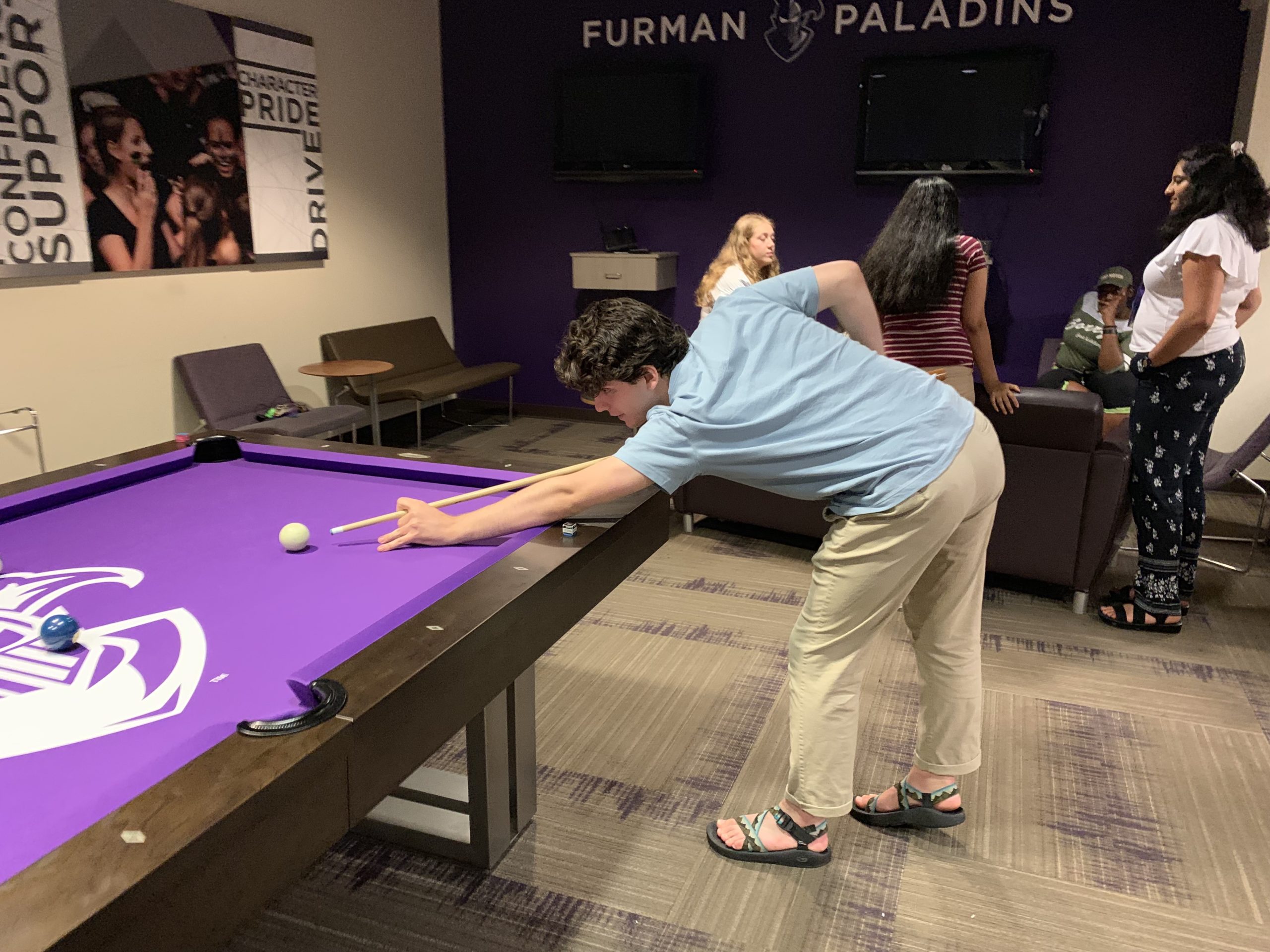 Jake playing billiards at the union on campus