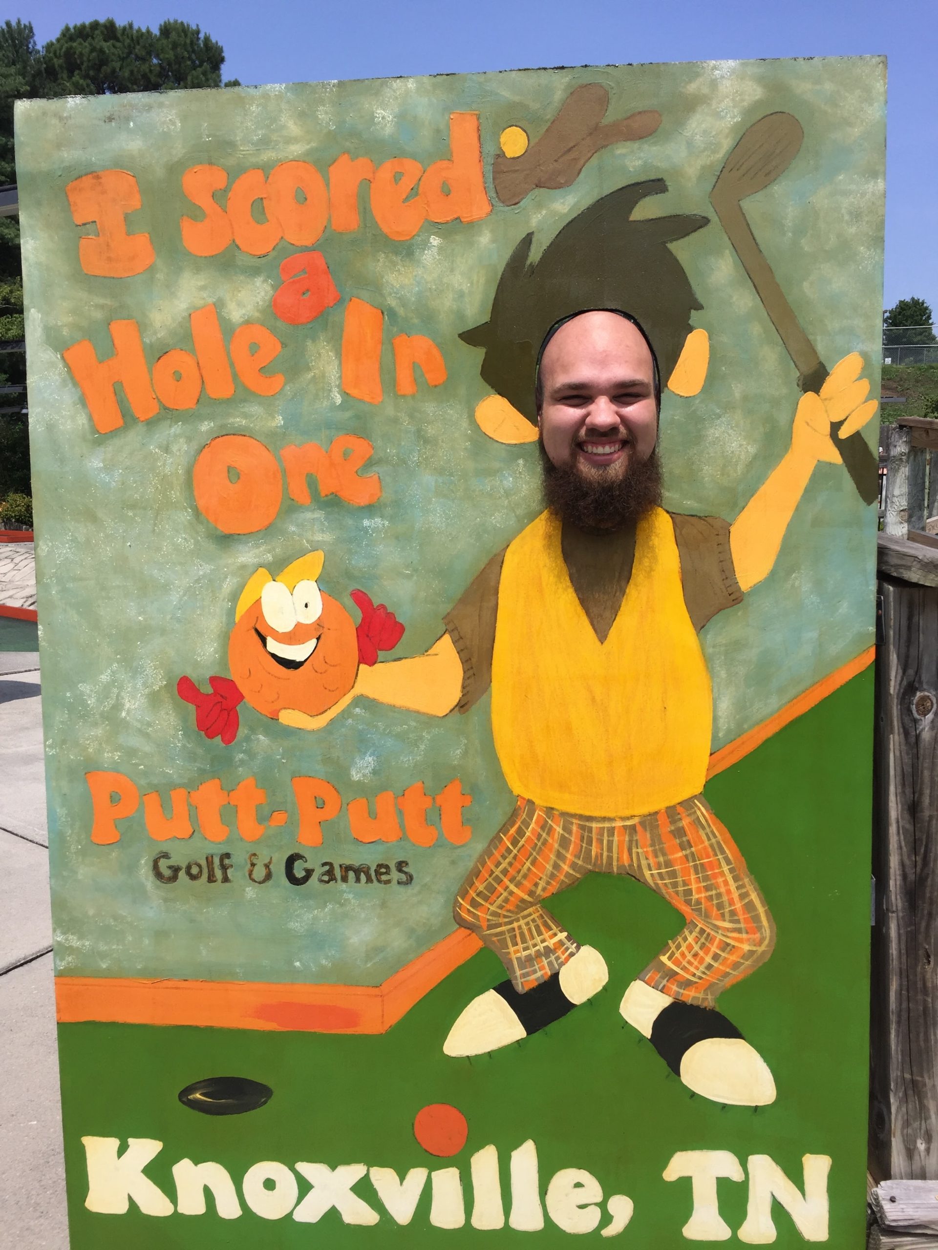 John posing after scoring a hole in one at mini-golf!