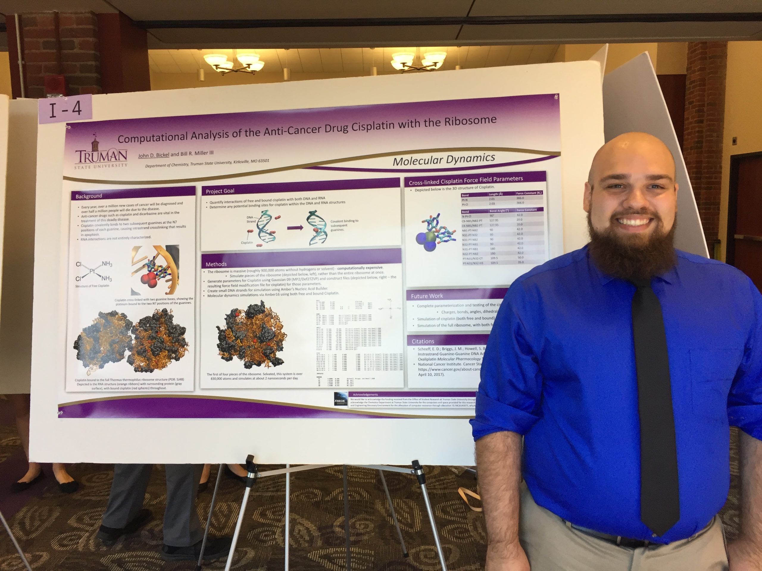 John in front of his research poster