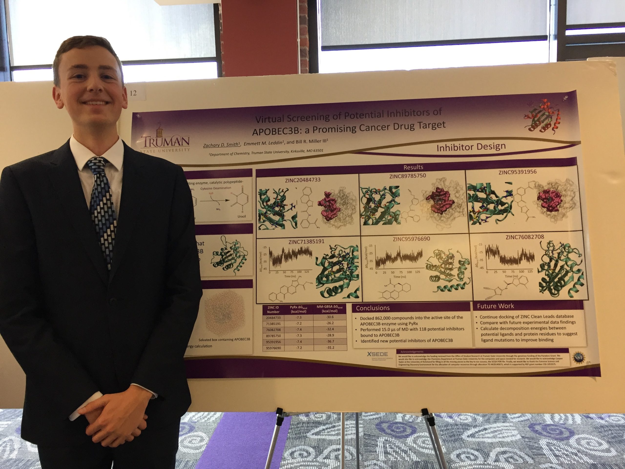 Zachary in front of his research poster