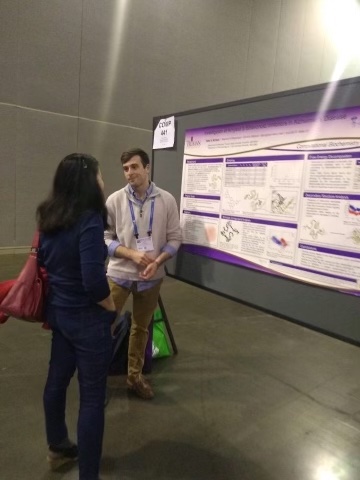Peter talking to a meeting participant during his poster session