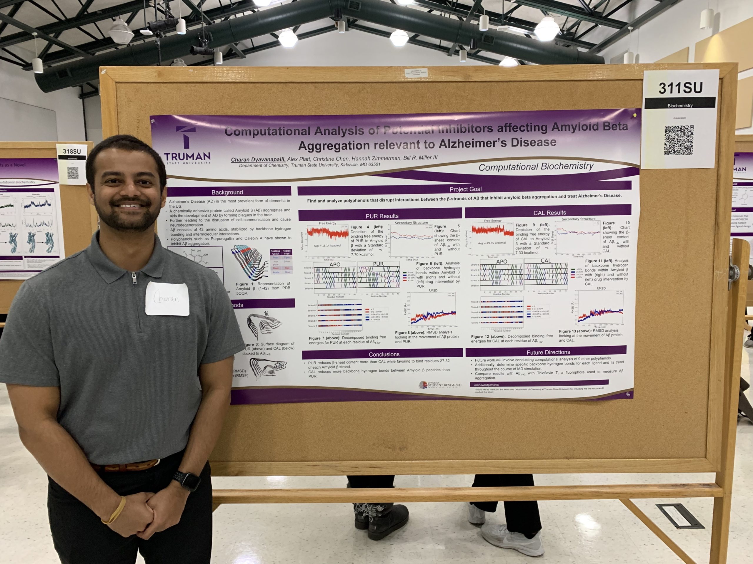Charan in front of his research poster