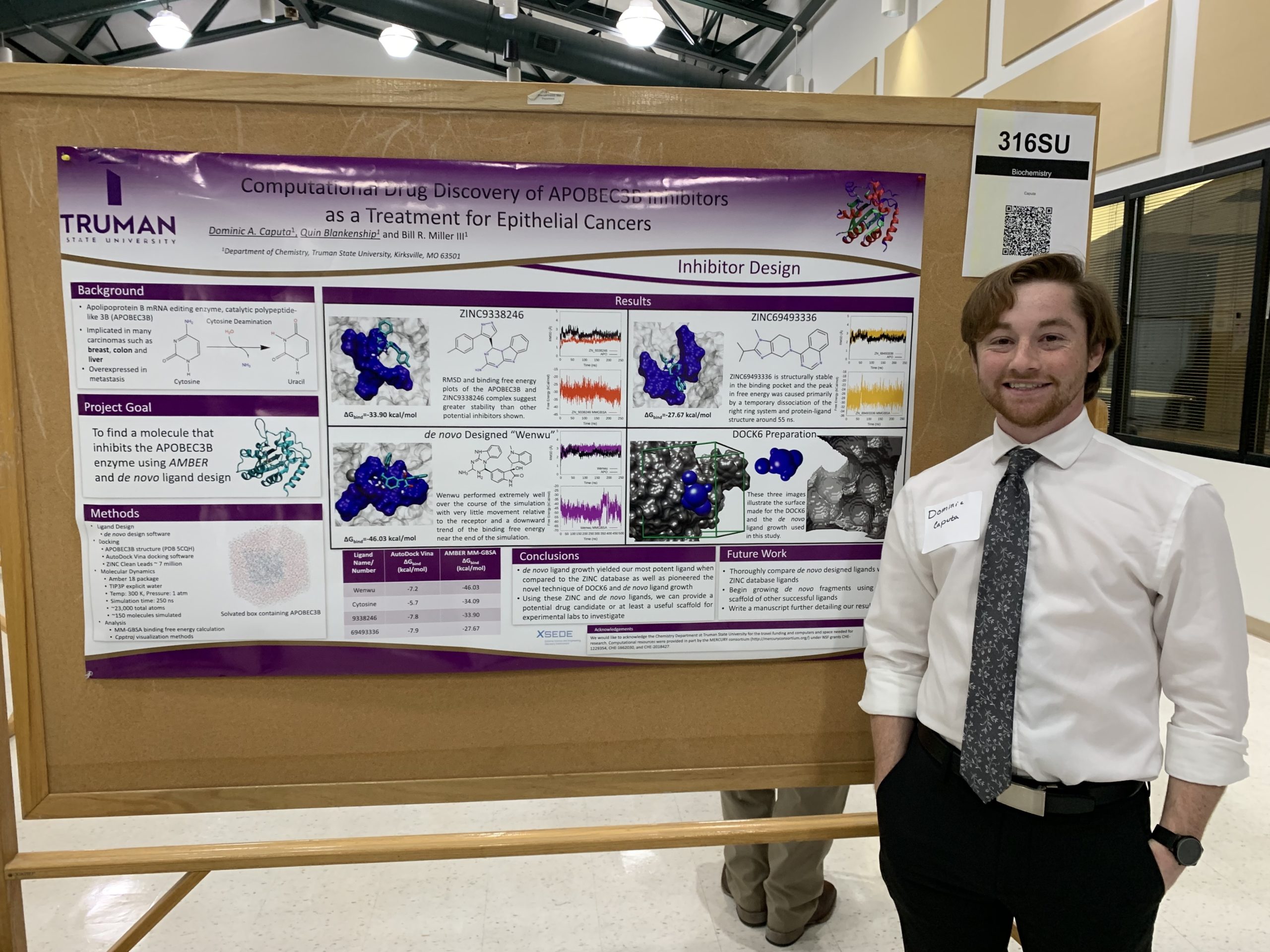 Dominic in front of his research poster