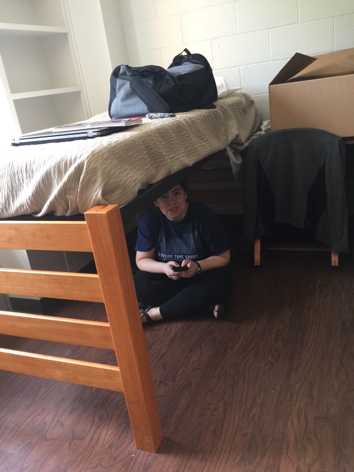 Ari hiding under a bed