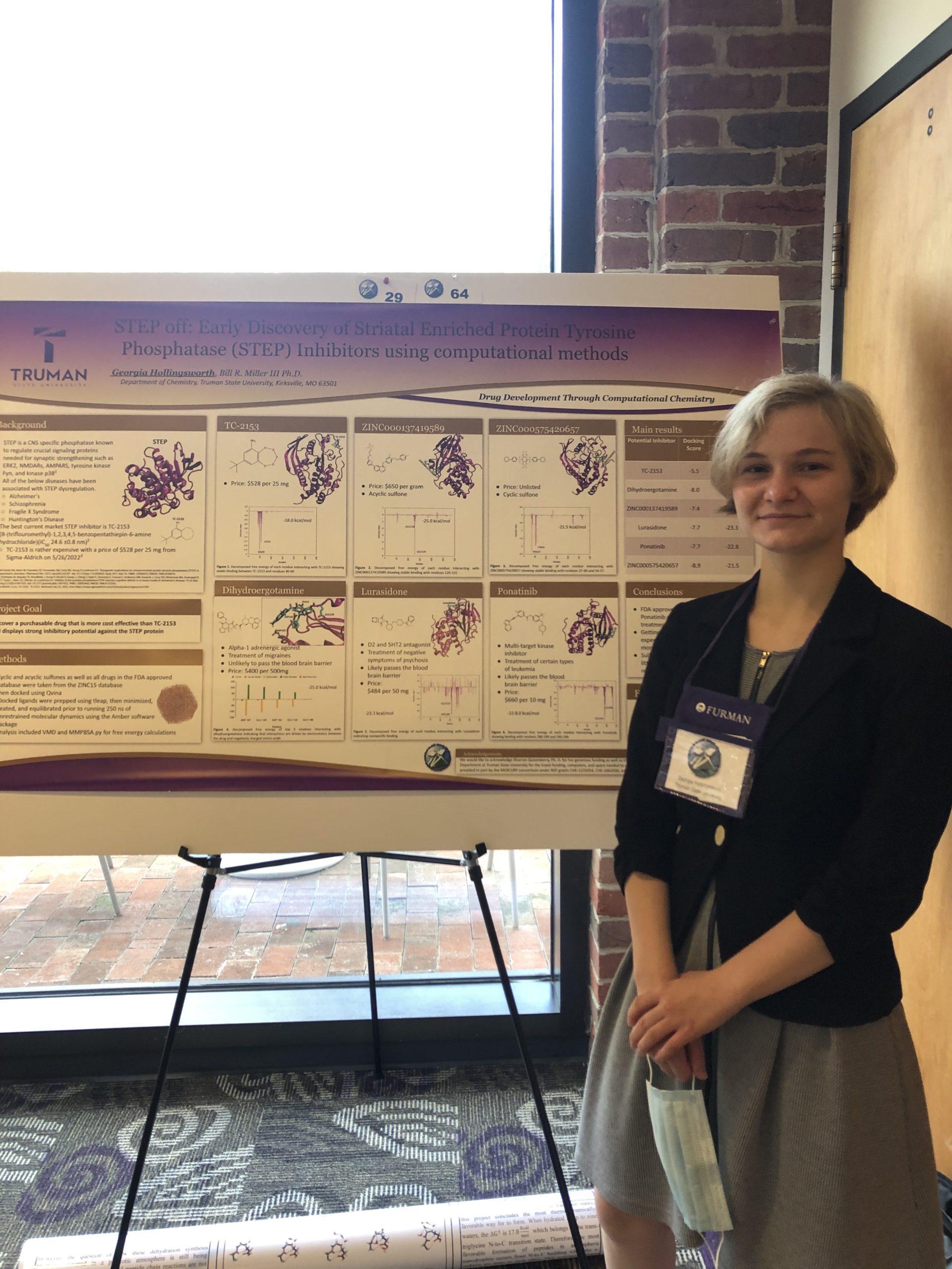 Georgia in front of her research poster